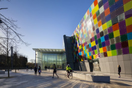 The Glass Mill Leisure Centre is situated on the lowest three floors of a 27 storey apartment building in Lewisham. The leisure centre includes 1400 glass panels in ten colours illuminated from behind. The lighting responds to the sounds outside of the centre. The new facility was designed by LA Architects and is managed by Fusion Lifestyle on behalf of Lewisham Council. The contractor for the project was Pellikaan, with additional work coming from Barratt Homes. The new centre features a 100-station fitness suite, a 25m, 8-lane swimming pool, a teaching pool, two group exercise studios, a rock climbing wall, a crèche, café and health suite, which includes a sauna, steam room, ice room and a relaxation area.