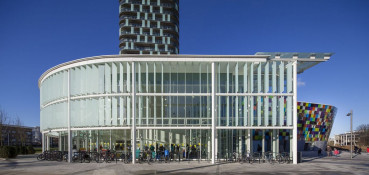 The Glass Mill Leisure Centre is situated on the lowest three floors of a 27 storey apartment building in Lewisham. The leisure centre includes 1400 glass panels in ten colours illuminated from behind. The lighting responds to the sounds outside of the centre. The new facility was designed by LA Architects and is managed by Fusion Lifestyle on behalf of Lewisham Council. The contractor for the project was Pellikaan, with additional work coming from Barratt Homes. The new centre features a 100-station fitness suite, a 25m, 8-lane swimming pool, a teaching pool, two group exercise studios, a rock climbing wall, a crèche, café and health suite, which includes a sauna, steam room, ice room and a relaxation area.