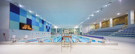 The Glass Mill Leisure Centre is situated on the lowest three floors of a 27 storey apartment building in Lewisham. The leisure centre includes 1400 glass panels in ten colours illuminated from behind. The lighting responds to the sounds outside of the centre. The new facility was designed by LA Architects and is managed by Fusion Lifestyle on behalf of Lewisham Council. The contractor for the project was Pellikaan, with additional work coming from Barratt Homes. The new centre features a 100-station fitness suite, a 25m, 8-lane swimming pool, a teaching pool, two group exercise studios, a rock climbing wall, a crèche, café and health suite, which includes a sauna, steam room, ice room and a relaxation area.