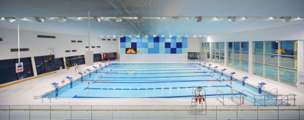 The Glass Mill Leisure Centre is situated on the lowest three floors of a 27 storey apartment building in Lewisham. The leisure centre includes 1400 glass panels in ten colours illuminated from behind. The lighting responds to the sounds outside of the centre. The new facility was designed by LA Architects and is managed by Fusion Lifestyle on behalf of Lewisham Council. The contractor for the project was Pellikaan, with additional work coming from Barratt Homes. The new centre features a 100-station fitness suite, a 25m, 8-lane swimming pool, a teaching pool, two group exercise studios, a rock climbing wall, a crèche, café and health suite, which includes a sauna, steam room, ice room and a relaxation area.