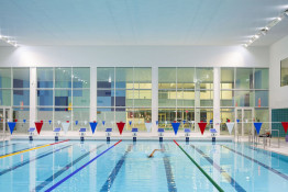 The Glass Mill Leisure Centre is situated on the lowest three floors of a 27 storey apartment building in Lewisham. The leisure centre includes 1400 glass panels in ten colours illuminated from behind. The lighting responds to the sounds outside of the centre. The new facility was designed by LA Architects and is managed by Fusion Lifestyle on behalf of Lewisham Council. The contractor for the project was Pellikaan, with additional work coming from Barratt Homes. The new centre features a 100-station fitness suite, a 25m, 8-lane swimming pool, a teaching pool, two group exercise studios, a rock climbing wall, a crèche, café and health suite, which includes a sauna, steam room, ice room and a relaxation area.