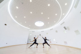 The Glass Mill Leisure Centre is situated on the lowest three floors of a 27 storey apartment building in Lewisham. The leisure centre includes 1400 glass panels in ten colours illuminated from behind. The lighting responds to the sounds outside of the centre. The new facility was designed by LA Architects and is managed by Fusion Lifestyle on behalf of Lewisham Council. The contractor for the project was Pellikaan, with additional work coming from Barratt Homes. The new centre features a 100-station fitness suite, a 25m, 8-lane swimming pool, a teaching pool, two group exercise studios, a rock climbing wall, a crèche, café and health suite, which includes a sauna, steam room, ice room and a relaxation area.