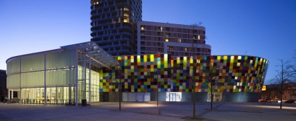 The Glass Mill Leisure Centre is situated on the lowest three floors of a 27 storey apartment building in Lewisham. The leisure centre includes 1400 glass panels in ten colours illuminated from behind. The lighting responds to the sounds outside of the centre. The new facility was designed by LA Architects and is managed by Fusion Lifestyle on behalf of Lewisham Council. The contractor for the project was Pellikaan, with additional work coming from Barratt Homes. The new centre features a 100-station fitness suite, a 25m, 8-lane swimming pool, a teaching pool, two group exercise studios, a rock climbing wall, a crèche, café and health suite, which includes a sauna, steam room, ice room and a relaxation area.