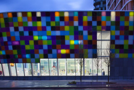 The Glass Mill Leisure Centre is situated on the lowest three floors of a 27 storey apartment building in Lewisham. The leisure centre includes 1400 glass panels in ten colours illuminated from behind. The lighting responds to the sounds outside of the centre. The new facility was designed by LA Architects and is managed by Fusion Lifestyle on behalf of Lewisham Council. The contractor for the project was Pellikaan, with additional work coming from Barratt Homes. The new centre features a 100-station fitness suite, a 25m, 8-lane swimming pool, a teaching pool, two group exercise studios, a rock climbing wall, a crèche, café and health suite, which includes a sauna, steam room, ice room and a relaxation area.