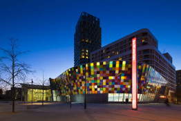 The Glass Mill Leisure Centre is situated on the lowest three floors of a 27 storey apartment building in Lewisham. The leisure centre includes 1400 glass panels in ten colours illuminated from behind. The lighting responds to the sounds outside of the centre. The new facility was designed by LA Architects and is managed by Fusion Lifestyle on behalf of Lewisham Council. The contractor for the project was Pellikaan, with additional work coming from Barratt Homes. The new centre features a 100-station fitness suite, a 25m, 8-lane swimming pool, a teaching pool, two group exercise studios, a rock climbing wall, a crèche, café and health suite, which includes a sauna, steam room, ice room and a relaxation area.